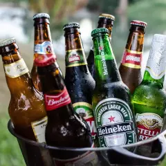 Kosz z butelkami piwa, w tym Heineken i Stella Artois, gotowy na letnie spotkanie. Idealne piwo w Niemczech na upalne dni.