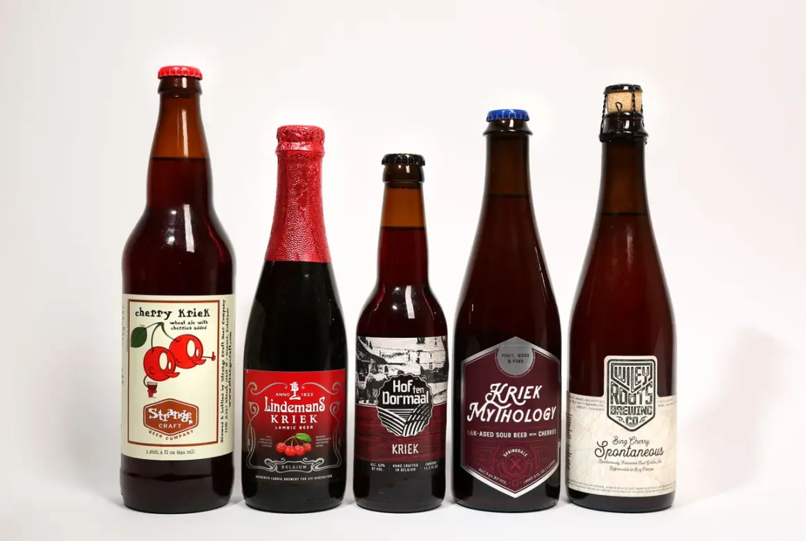 Pięć butelek belgijskiego piwa wiśniowego, w tym Kriek Mythology i Lindemans Kriek.